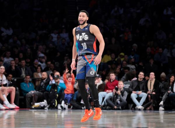 Basketball player Ben Simmons (#10) in black jersey shorts with crowd during Brooklyn Nets vs Utah Jazz game at Barclays Center.