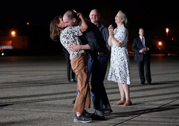 Gershkovich (seen embracing his mother Ella Milman after his arrival at Joint ba<em></em>se Andrews on Aug. 1) was among two dozen people freed as part of a priso<em></em>ner swap.