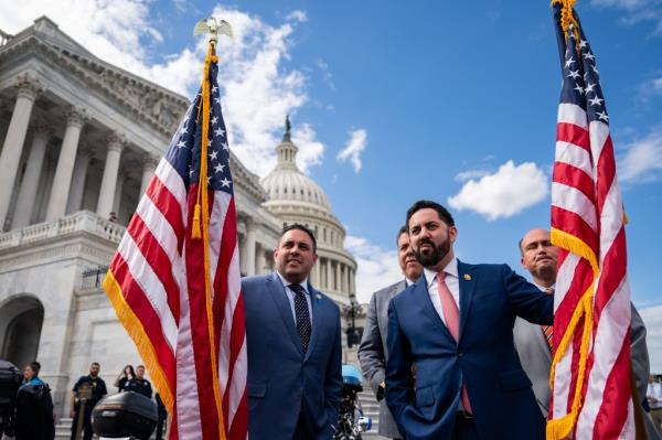 Rep. Anthony D'Esposito (R-NY) and Rep. Michael Lawler (R-NY) holding american flags outside the capitol