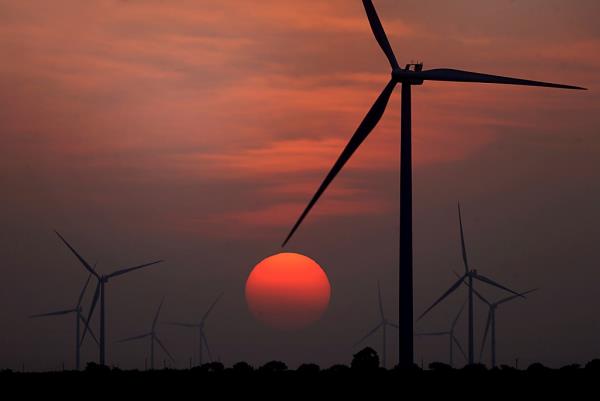 The sun sets at wind farm in McCook, Texas.