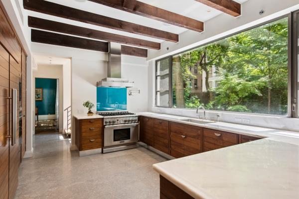 Chef's kitchen with wood beamed ceiling at 160 East 83rd Street real estate