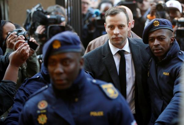 Olympic and Paralympic track star Oscar Pistorius is escorted by police officers as he arrives for his sentencing for the 2013 murder of his girlfriend Reeva Steenkamp, at North Gauteng High Court in Pretoria, South Africa on July 6, 2016. 