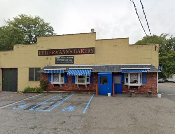 Holtermann's Bakery in Staten Island, a building with blue awnings and a sign, owner Jill Holtermann refutes Goldberg's claim a<em></em>bout refusing birthday dessert order due to political reasons.
