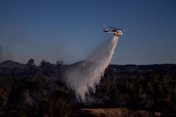 A Cal Fire Sikorsky S70i Firehawk helicopter performs a water dro<em></em>p on a hot spot during the Boyles fire in Clearlake, Calif., Sunday, Sept. 8, 2024.