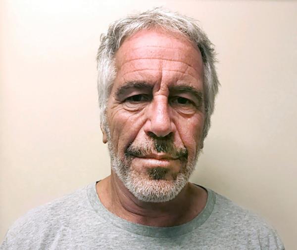 Jeffrey Epstein smiling. 