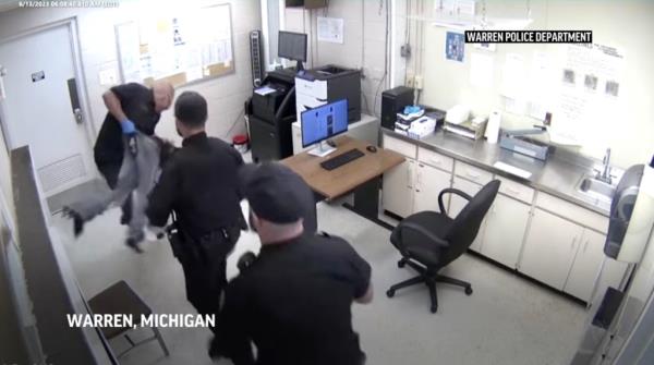 Screenshot of the moment the officer picked up the beaten suspect.