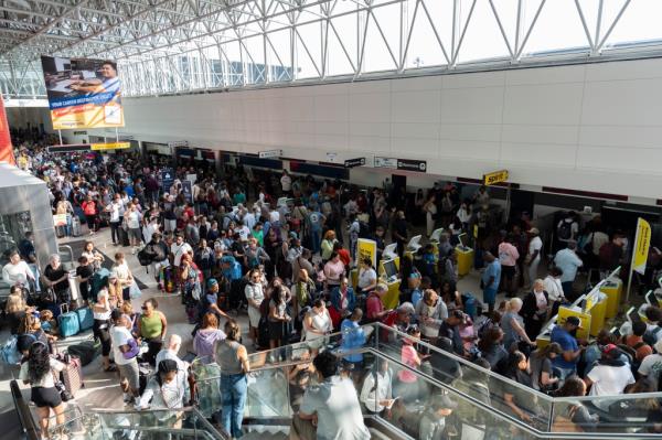 Travelers wait in line at Baltimore/Washington Internatio<em></em>nal Thurgood Marshall Airport in Baltimore, Friday, July 19, 2024.