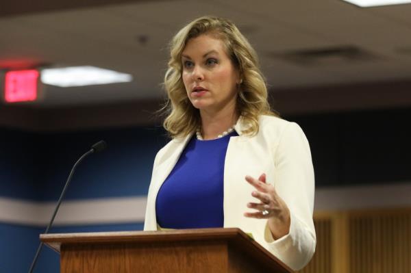 Attorney Ashleigh Merchant speaking at a podium during the State of Georgia v. Do<em></em>nald John Trump misco<em></em>nduct hearing at the Fulton Co. Courthouse.