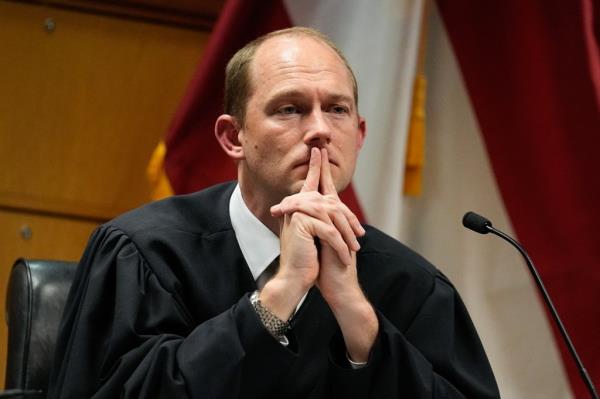 Judge Scott McAfe in black robe presides over a hearing into misco<em></em>nduct allegations against Fulton County DA Fani Willis in the Fulton County Courthouse.