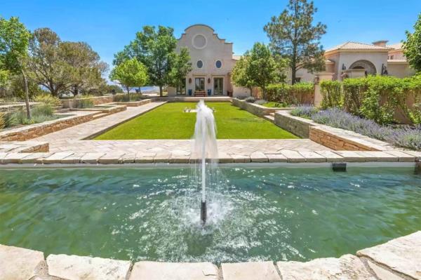 A fountain sits on the main house.