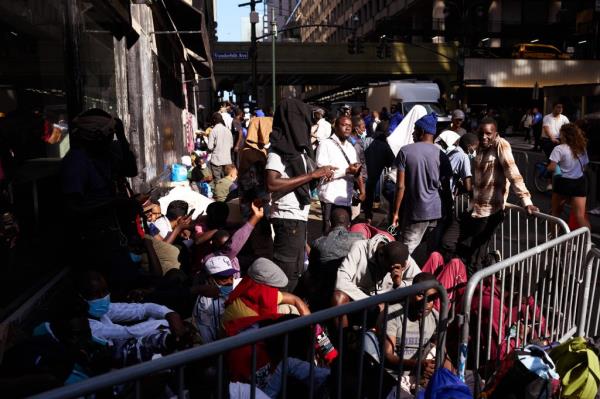 A crowd of migrants lined up outside of the shelter at the Roosevelt Hotel in Manhattan on August 2, 2023.