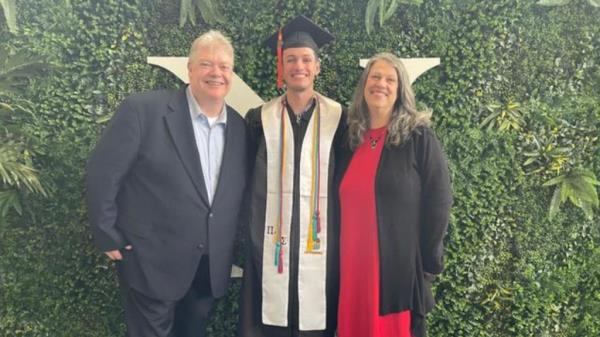 Jennings is pictured at graduation with his mother and father.