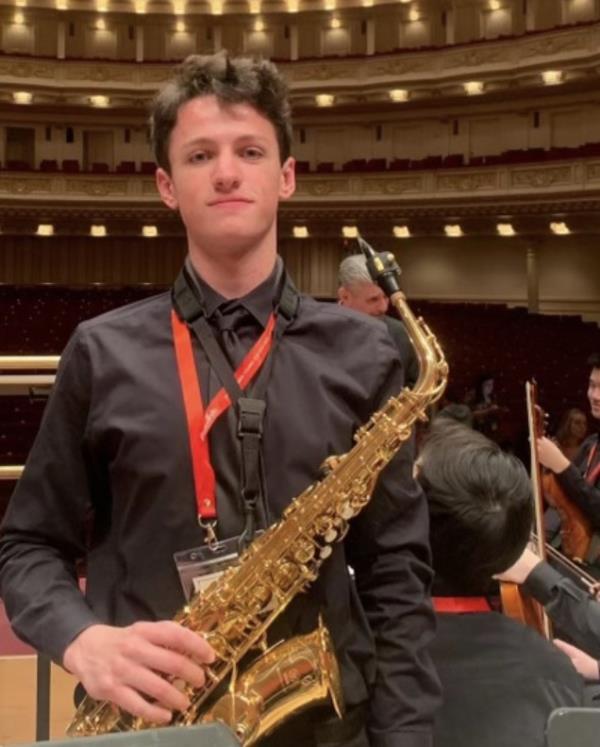 Will is pictured with his saxophone.