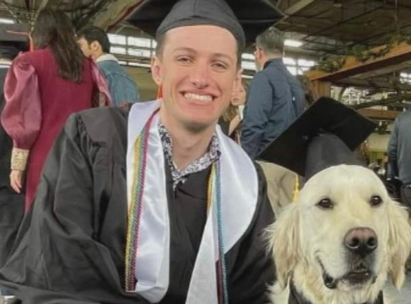 Jennings is pictured at graduation with his dog.