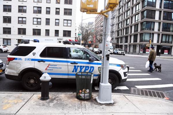 A NYPD car blocking a fire hydrant ant crosswalk on Third Ave. in Manhattan.