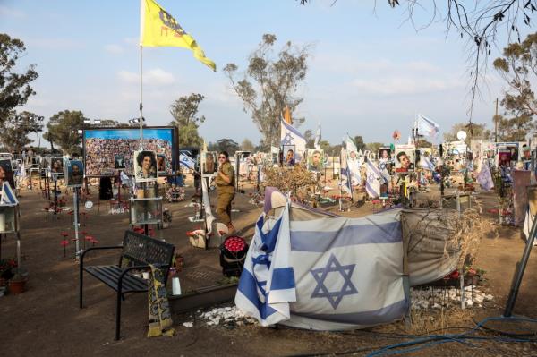 A woman walks, as people visit the site of the Nova festival, wher<em></em>e partygoers were killed and kidnapped during the October 7 attack