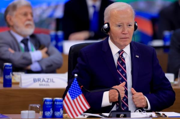 Joe Biden sitting at a table wearing headphones