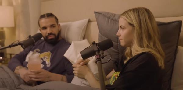 Drake in bed with Bobbi Althoff, with micropho<em></em>nes in front of them.