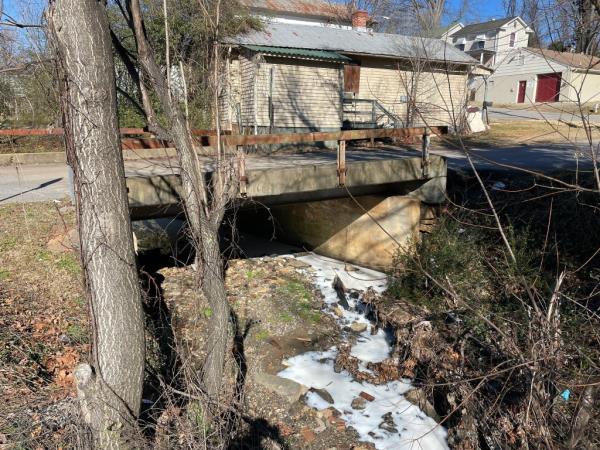 The white-colored creek is seen flowing after it was dyed by 