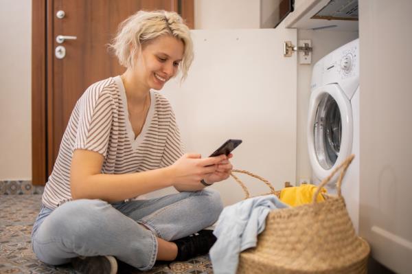 Young woman doing her laundry at home