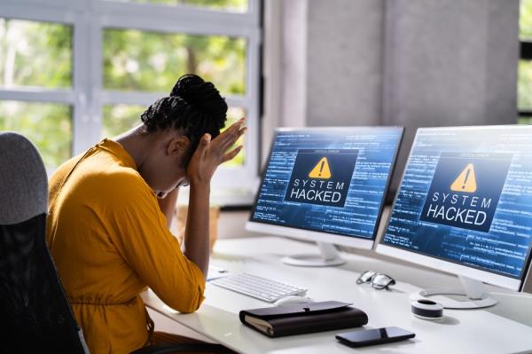 Computer System Hacked. Virus Software Screen On Monitor.