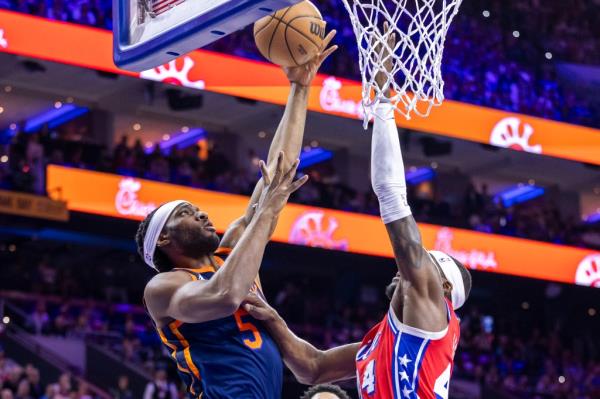 Precious Achiuwa goes up for a layup as Philadelphia's Paul Reed defends during Game 4 on Sunday.