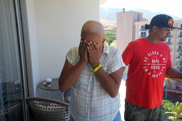 Makalea Ahhee, left, tears up while her husband, JP Mayoga, right, a chef at the Westin Maui, Kaanapali, stand on their balcony at the hotel and resort,