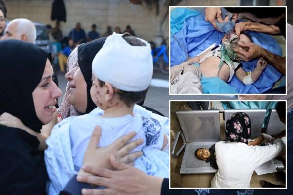A Palestinian girl wounded in Israeli strikes is assisted at Al Shifa hospital, in Gaza City, November 9, 2023. 