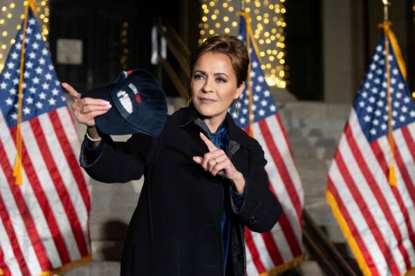 Republican Senate candidate Kari Lake prepares to throw a hat to a supporter during a campaign rally outside of Yavapai County Courthouse in Prescott, Arizona, on November 4, 2024.