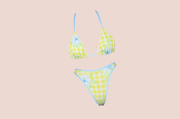 Genesis Rodriguez wearing a yellow and blue swimsuit
