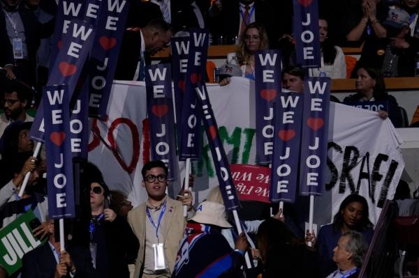 Others in the crowd tried to block the woman's sign from view with their own towering placards.