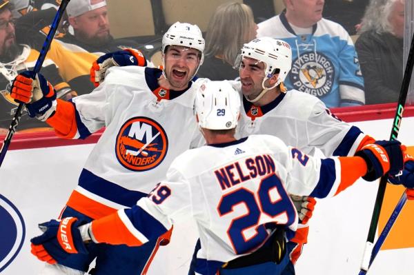 Islanders' Adam Pelech (3) celebrates his game-winning goal in overtime against the Penguins in Tuesday with Kyle Palmieri (21) and Brock Nelson.