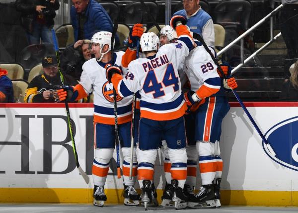 The Islanders celebrate their overtime win over the Penguins on Tuesday night.