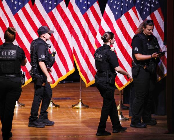 Secret Service perso<em></em>nnel walking across the stage at a Do<em></em>nald Trump campaign event in Asheville, North Carolina.