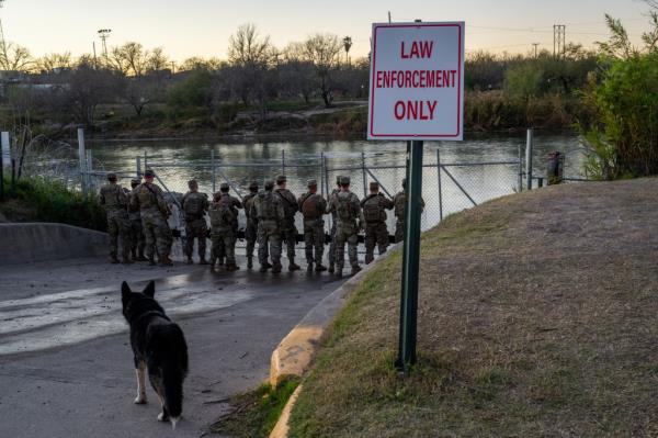 Natio<em></em>nal Guard soldiers stand guard on the banks of the Rio Grande river at Shelby Park on January 12, 2024 in Eagle Pass, Texas.