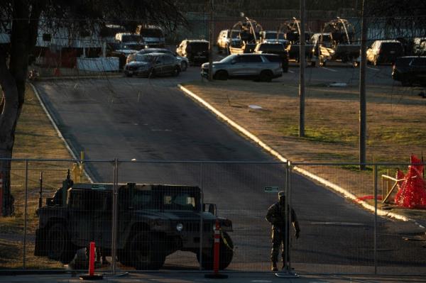 A Natio<em></em>nal Guard soldier stands guard at the gate of Shelby Park which is now used as an operation center in Eagle Pass, Texas, on Jan. 17, 2024.