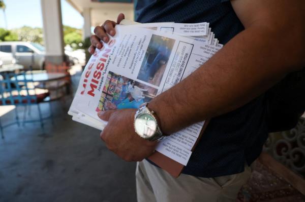 Tim Laborte holds 'MISSING' flier featuring a photo of his stepfather, Joseph Lara, who is missing