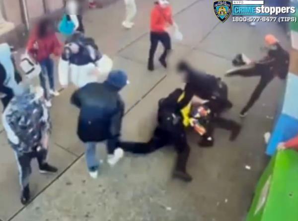 A CrimeStoppers screenshot of cops being beaten by a migrant mob.