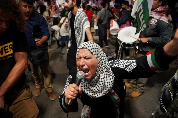 Demo<em></em>nstrators waved signs, Palestinian flags and used bullhorns to chant phrases like 