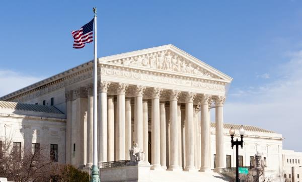 Facade of US Supreme court in Washington DC on sunny day.