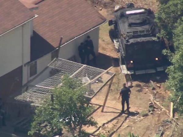 Several neighbors managed to capture the terror as officers scrambled to seek cover and heavily-armed law enforcement started returning fire with snipers. 
