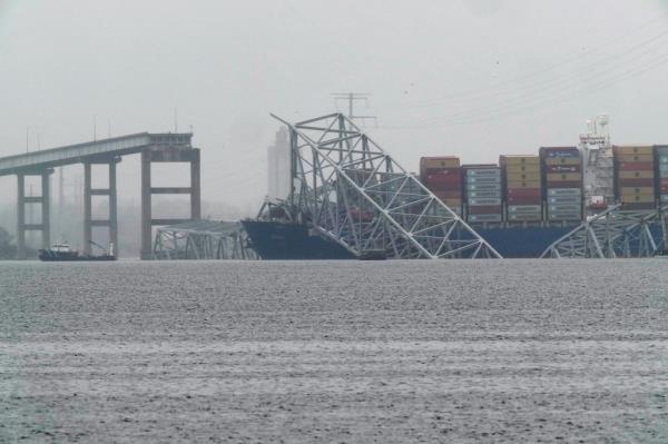 A co<em></em>ntainer ship rests against the wreckage of the Francis Scott Key Bridge on Thursday, March 28, 2024.