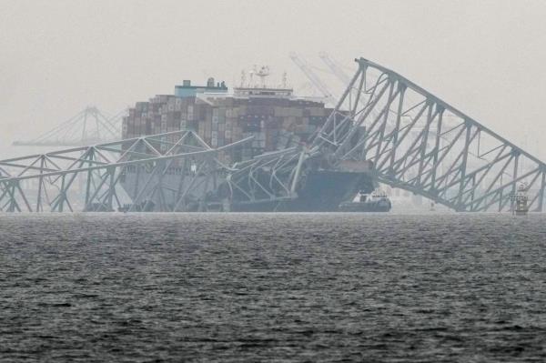 A co<em></em>ntainer ship rests against the wreckage of the Francis Scott Key Bridge on Thursday, March 28, 2024.