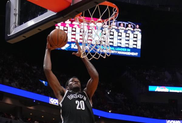 Day'Ron Sharpe, who scored 19 points and grabbed 11 rebounds, goes up for a dunk during the Nets' 107-104 preseason win over the Heat.