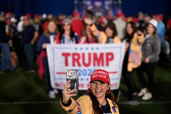 Kristy Grosfeld taking a selfie with a crowd of people in the background at a campaign event for former President Do<em></em>nald Trump.