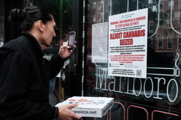 A state of New York notice posted at a business announces the seizure of 'illicit cannabis' at the business as authorities crack down on unlicensed smoke shops on June 16, 2023 in New York City