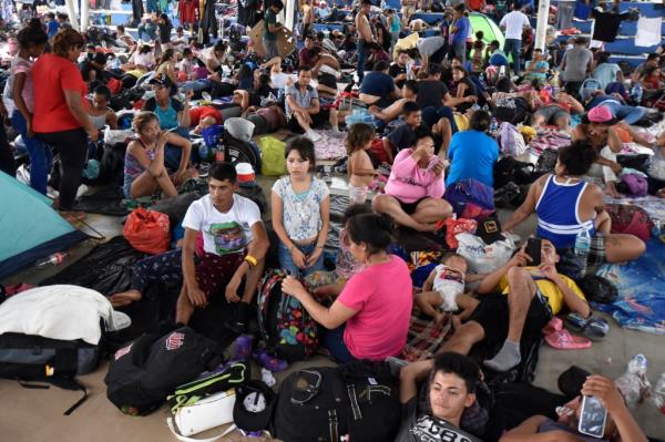 Migrants waiting for their temporary transit papers relax while on their way to the US-Mexico border on Nov. 1, 2023.