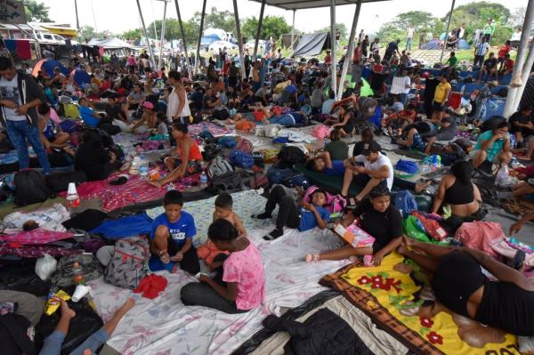 Migrants who failed to receive temporary transit papers after waiting up to mo<em></em>nths for them, rest at a sports complex in Huixtla, Mexico on Wednesday, Nov. 1, 2023.