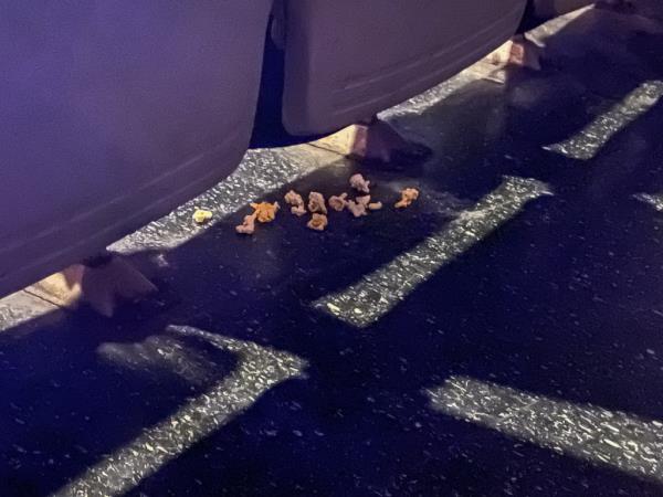 Popcorn litters the floor in one movie aisle.