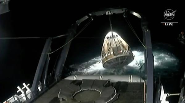 This screen grab taken from the NASA live feed shows the SpaceX Crew Dragon Endeavour spacecraft being lifted o<em></em>nto the recovery vessel after splashdown off the coast of Jackso<em></em>nville on Sep. 4, 2023. 